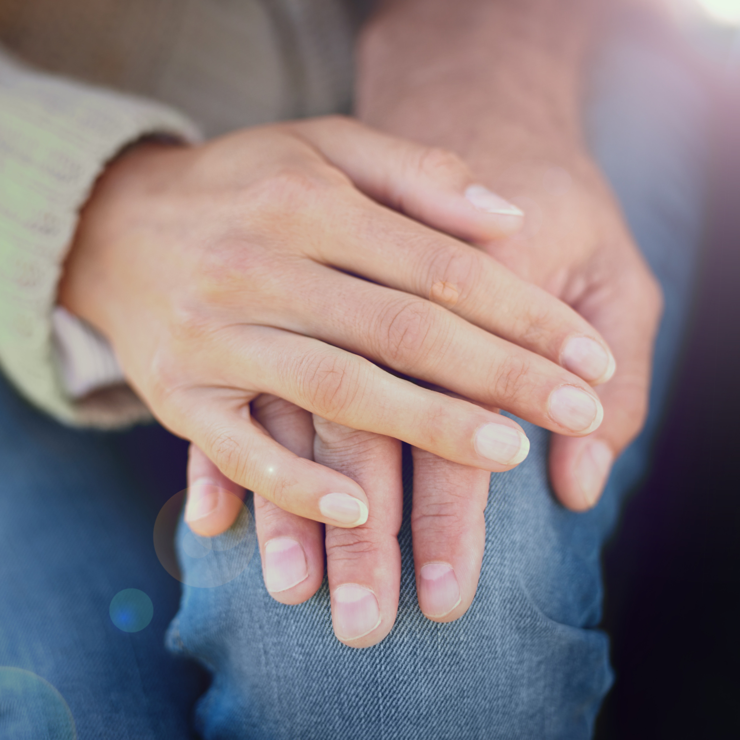Hands gently held in support — compassionate domiciliary care